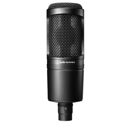 Audio-Technica condenser microphone facing forward with a metal grille in a black body, for recording and studio use in a professional setup.