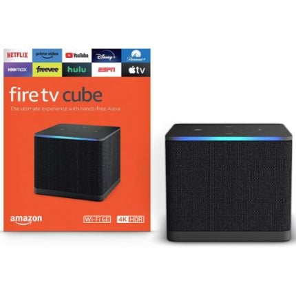 Fire TV Cube box (orange) next to a black cube speaker with a blue light ring on top showing streaming logos above.
