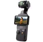 DJI Osmo-style handheld gimbal with a small touchscreen showing a person in a mountain landscape