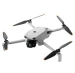 White quadcopter drone with four propeller arms and a forward-facing camera on a gimbal