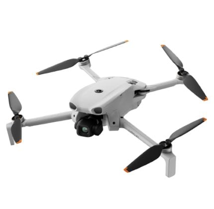 White quadcopter drone with four propeller arms and a forward-facing camera on a gimbal