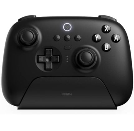 Black wireless game controller resting on a cradle, showing left joystick, D‑pad, right joystick, and the A, B, X, Y buttons on the right.