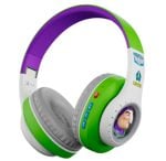 Over-ear headphones for kids in green, purple, and white with a cartoon character image on the earcup.