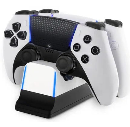 White PlayStation-style game controller on a black dual‑charging dock with blue LED accents, and a second controller resting in the background.