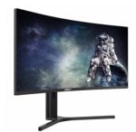 Curved computer monitor on a stand displaying a space scene with an astronaut near Earth on screen.