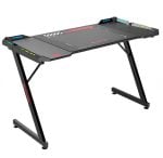 Black carbon-fiber-style gaming desk with angled X-frame legs and a wide top, featuring control panels along the edges for settings and lighting.