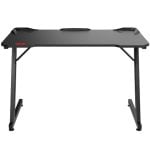 Black gaming desk with carbon-fiber top, red logo on the left, and a sturdy dual-leg frame.