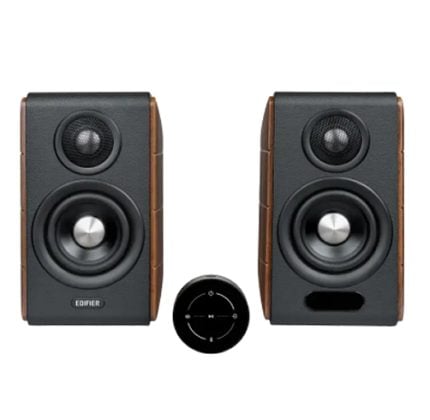 Pair of black bookshelf speakers with wooden sides and a circular wireless remote between them; left speaker shows the Edifier branding.