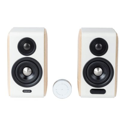 Pair of white wooden bookshelf speakers with black drivers and a small round wireless adapter between them.