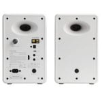 Pair of white studio monitor speakers viewed from the back, showing input ports and power area on each unit for connection.