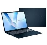 Open ASUS VivoBook laptop showing a blue geometric wallpaper; a second dark blue VivoBook is closed in the background.