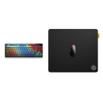 Compact RGB-lit keyboard on the left and a large black SteelSeries mouse pad on the right.
