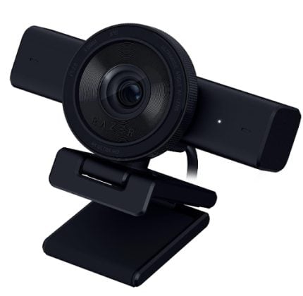 Black external webcam with a large central lens mounted on a foldable, adjustable stand.