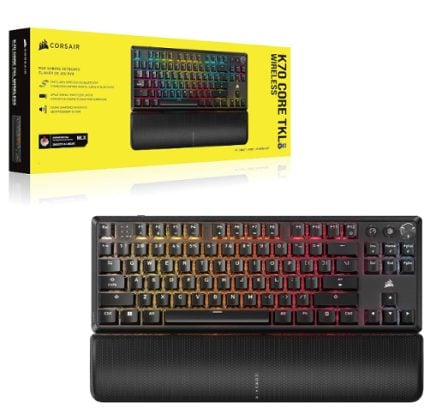 Corsair K70 Core RGB Wireless keyboard with rainbow backlighting and a textured wrist rest, shown in front of its yellow product box.
