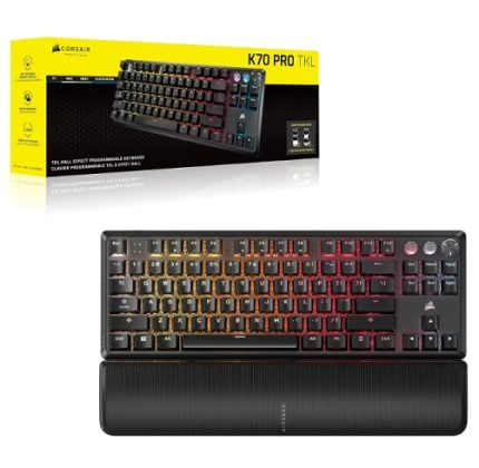 Corsair K70 Pro mechanical keyboard with rainbow RGB lighting and a matching wrist rest, pictured with its yellow box in the background.