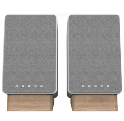 Pair of Onkyo speakers with gray fabric fronts and wooden bases arranged side by side.