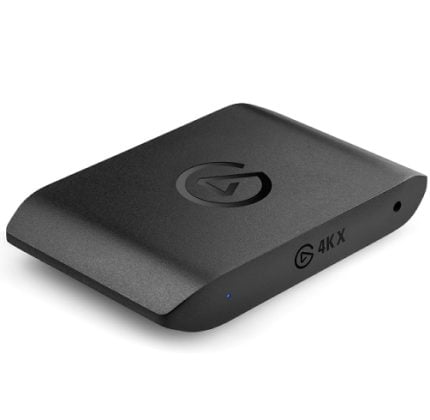 Black compact streaming device with rounded edges, a subtle logo on top, and a blue LED indicator showing power/active status.