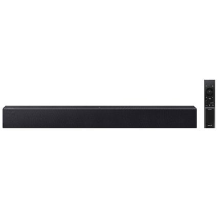 Long black soundbar with a textured grille, placed horizontally, with a tall remote to its right.