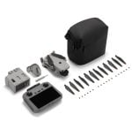 Drone kit with gray controller, spare propellers, batteries, charger, and a black carrying case.