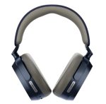Over-ear headphones in dark navy with beige ear cushions, angled to show the ear cups