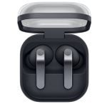 Open charging case with two wireless earbuds inside; dark gray case with a translucent lid and silver stems.