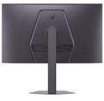 Rear view of a dark monitor on a tall pedestal stand, with I/O ports visible on the back-right edge.