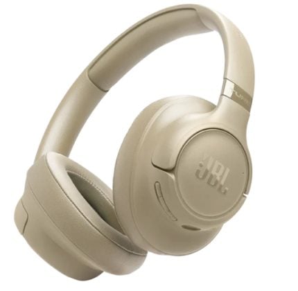 Beige JBL over-ear headphones with cushioned ear cups and headband, angled to show ear cup branding.