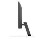 Side view of a slim computer monitor on a tilted stand, base resting on a desk.